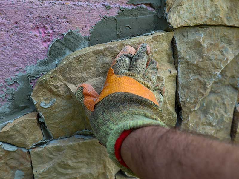 shutterstock_1701689065 masonry stone wall repair stone wall restoration