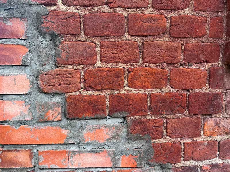 shutterstock_1701689065 old brick wall repair